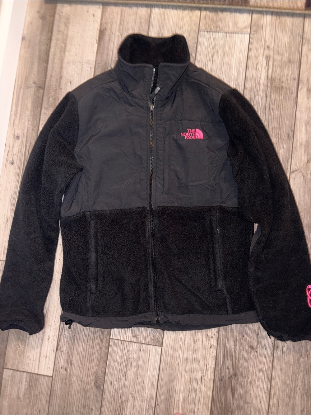 The North Face women’s Black Fleece Puffer Jacket with Pink breast cancer Logo
